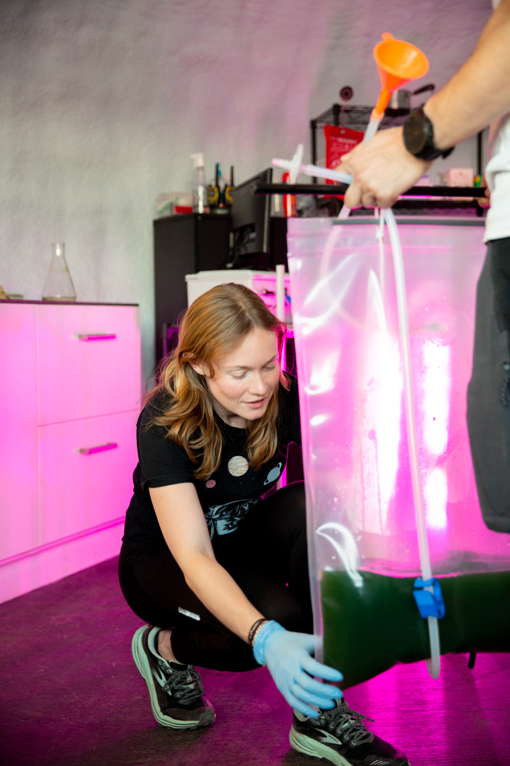 Cecile holding the spirulina colony in a large plastic bag